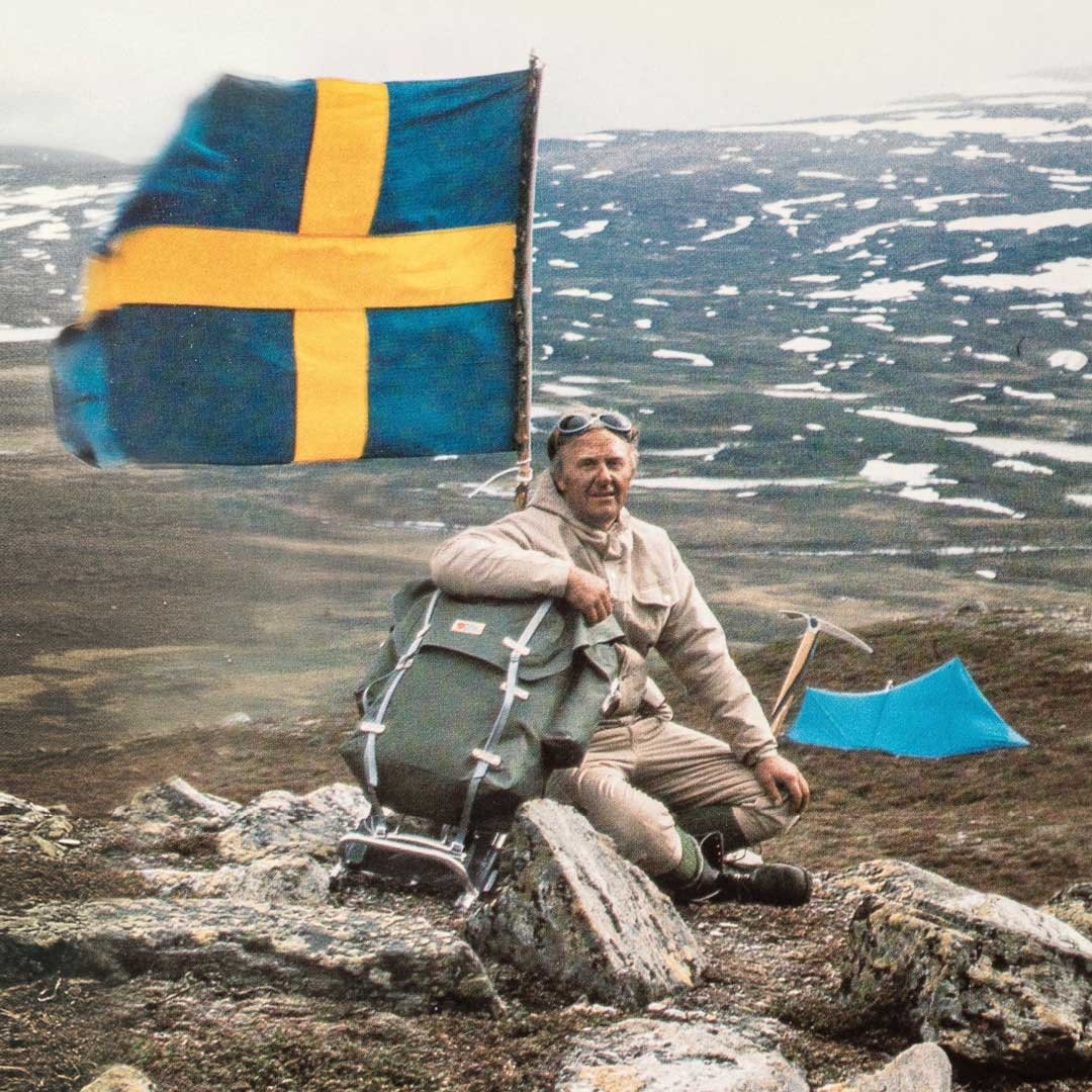 Historic photo of man on mountaintop with Swedish flag 