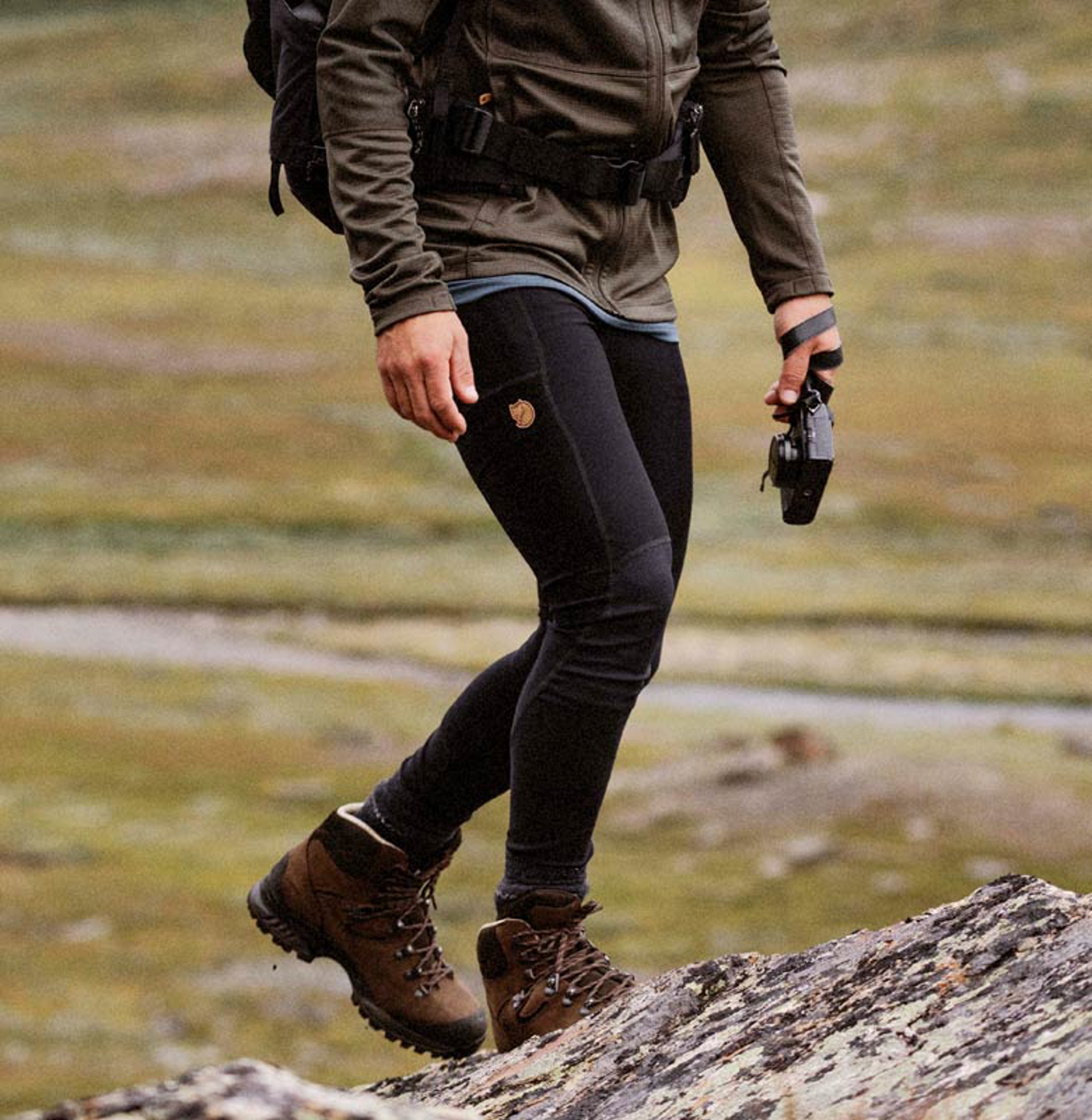 a person hiking with a camera in Fjallraven apparel